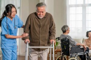 A nurse helping senior residents during an emergency drill with safety equipment and supplies visible.