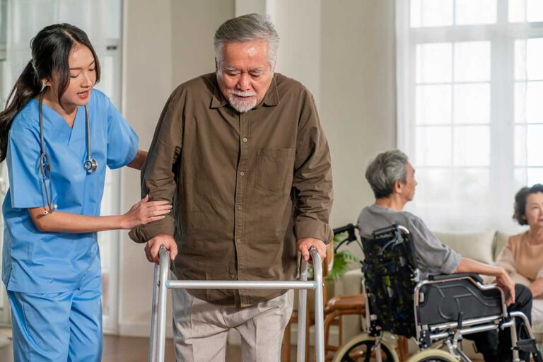 A nurse helping senior residents during an emergency drill with safety equipment and supplies visible.